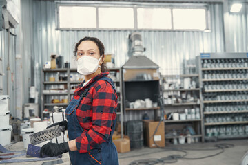 Attentive female mechanic preparing instrument for polishing