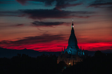Obraz premium Sky on fire at sunset on a view of a temple ruin in old Bagan, Myanmar