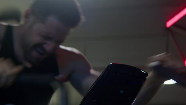an athlete preforming an intense workout Packing self above limit,  sweating ,in Pain, cycling so fast