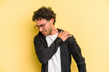 Fototapeta na wymiar Young caucasian man isolated on yellow background having a shoulder pain.