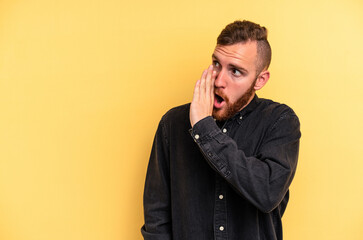 Fototapeta premium Young caucasian man isolated on yellow background being shocked because of something she has seen.
