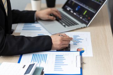 Businessman or accountant financial expert analyze business report graph and finance chart in office. Concept of finance economy, banking business and stock market research.