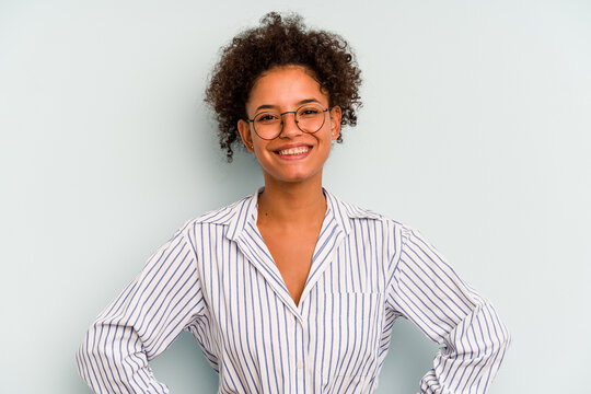Young Brazilian woman isolated on blue background confident keeping hands on hips.