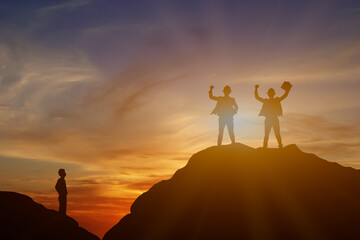 Silhouette of men who look at successful businessman on top mountain, sky and sun light background.