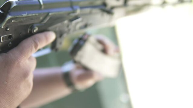 Soldier inserts cartridge into a magazine and reload the rifle ak-74 close-up