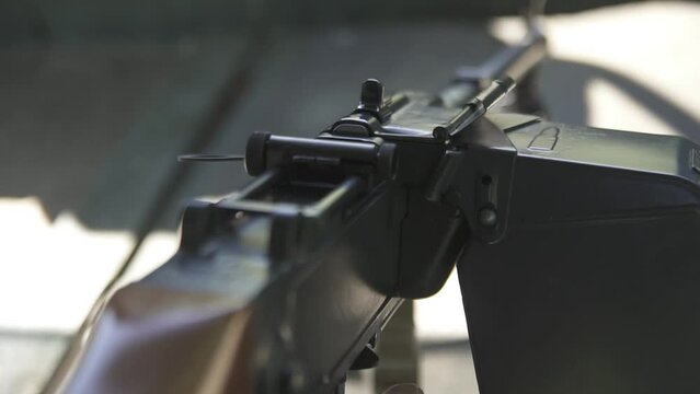 Man reloads a machine gun at shooting range close-up
