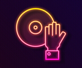 Glowing neon line DJ playing music icon isolated on black background. Vector