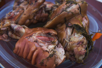 Traditional czech roast pork knuckle on spit. Big pieces of meat in street food market. the concept of cooking on an open fire.