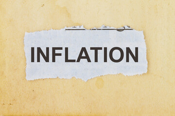 Inflation as written in an old cutout newspaper concept for inflation rates