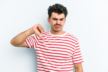 Young caucasian man isolated on blue background showing thumb down, disappointment concept.