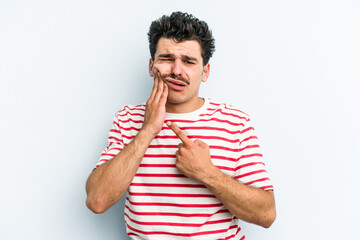 Young caucasian man isolated on blue background having a strong teeth pain, molar ache.