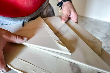 Cut tiles in builder's hands.