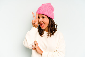 Young hispanic woman isolated on blue background shocked and amazed holding a copy space between hands.