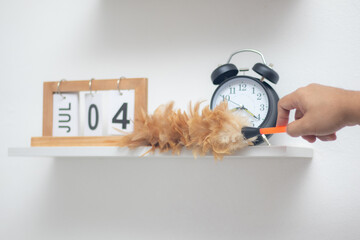 Use a feather duster to clean the clock work layer.