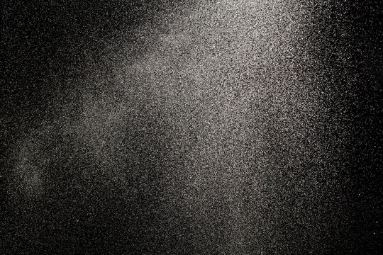 Sprayed water. Small droplets of water in the air. Lots of water drops, isolated on black background.