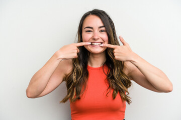 Young caucasian woman isolated on white background smiles, pointing fingers at mouth.