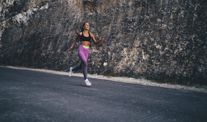Motivated female jogger in activewear and sneakers have morning workout for increase physical strength, sportive woman in tracksuit reaching ambitious vitality goals during run marathon challenge