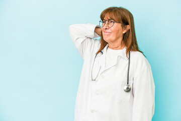 Middle age doctor woman isolated on pink background touching back of head, thinking and making a choice.