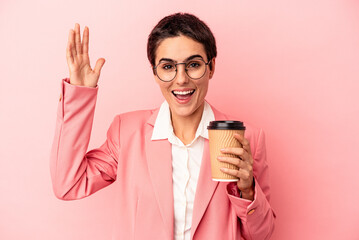 Young caucasian business woman holding a takeaway coffee isolated on pink background receiving a...