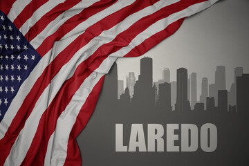 abstract silhouette of the city with text Laredo near waving national flag of united states of america on a gray background. 3D illustration