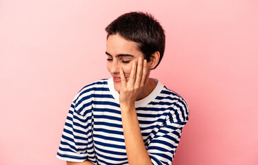 Young caucasian woman isolated on blue background laughs happily and has fun keeping hands on...