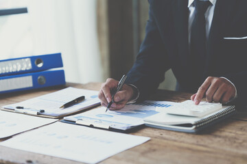 Businessman analysis marketing plan, Accountant calculate financial report, Accounting Calculating Cost Economic Financial data.