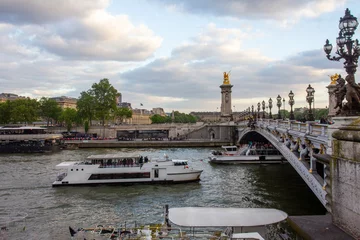 Many leisure boats in Seine river with people(  unrecognizable persons) , Bridge of Alexander 3  and Paris