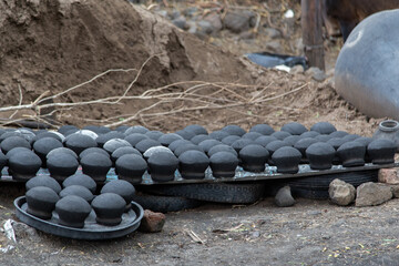 Black clay earthen pots kept to dry