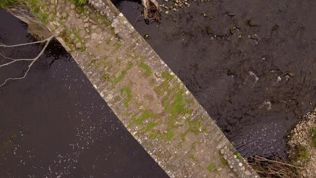 aerial rotating view looking down at cobbled cromwells bridge