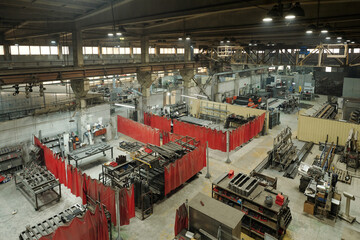 Above view of spacious industrial plants with group of workshops equipped with huge machines and metallic spare parts