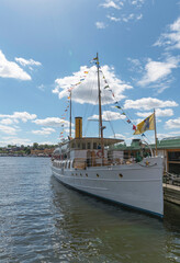 Naklejka premium Old steam ship at hire at a restaurant jetty a summer day in Stockholm