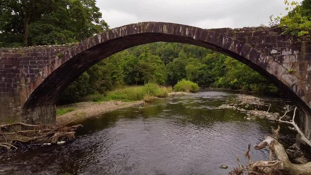 aerial rising view of cobbled pathway over cromwells bridge