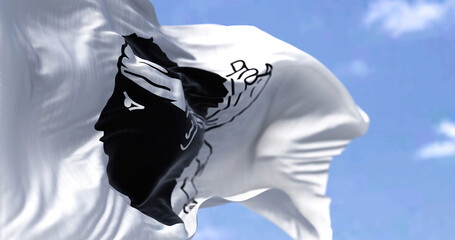 The flag of Corsica waving in the wind on a clear day
