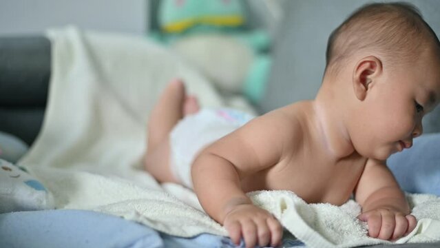 portrait of asian baby lying in bed
