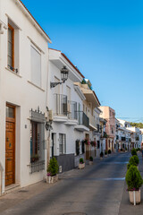 Fototapeta na wymiar Streets of city of Alhaurin de la Tore, situated in south of Spain in Malaga province. Typically Andalusian small streets with white houses 