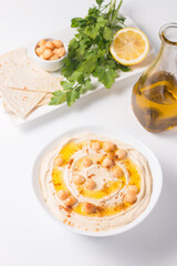 Hummus in a plate with chickpeas, smoked paprika, olive oil and pita. Vegetarian food.