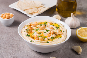 Hummus in a plate with chickpeas, smoked paprika, olive oil and pita. Vegetarian food.