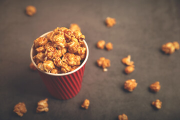 Delicious caramel popcorn in paper cups	
