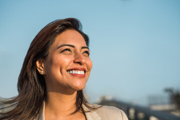 Close-up of a Latina woman smiling sideways. Copy space - Powered by Adobe