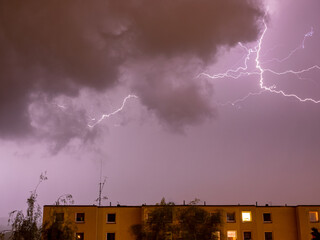 Thunderstorm with branching lightning over a residential house - long exposure