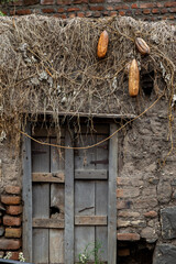 Traditional handmade broken wooden door for mud house. Old and vintage local style of architecture in Maharashtra, India