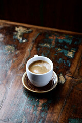 Cup of coffee on rustic wooden background. Copy space.
