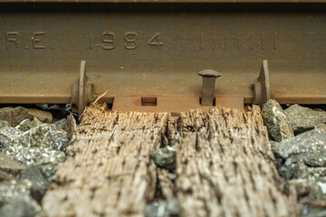 Bolts on a train track used by commuter and freight trains in a suburban town. 