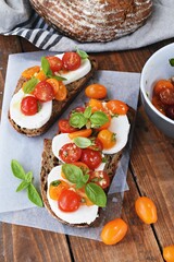 Sourdough bread toast with mozzarella, cherry tomatoes and basil
