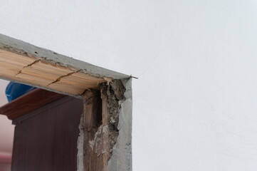 Wooden door opening, replacement and reconstruction of the old door in the room.