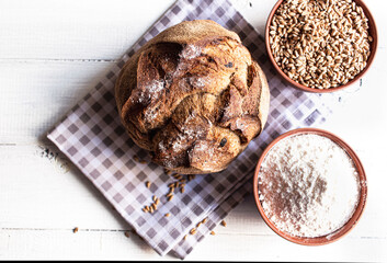 Round bread close-up. Freshly baked sourdough bread with a golden crust. Baker shop context with delicious bread.