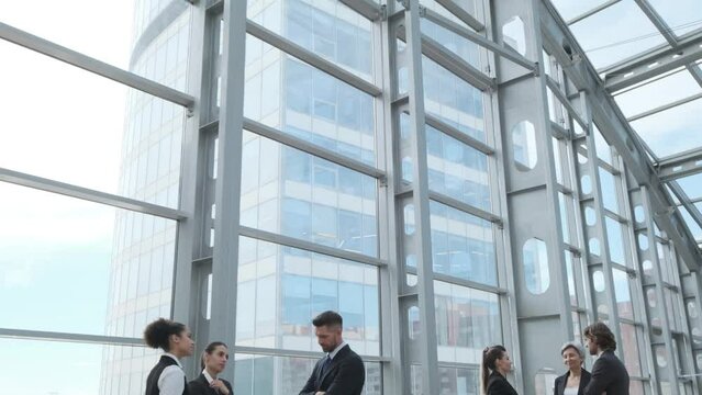 Diverse business people working together, office interior and skyscrapers. Concept of modern office with managers, partners