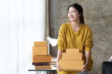 Starting small businesses SME owners female entrepreneurs check online orders to prepare to pack...