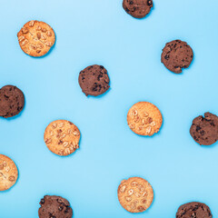 Chocolate cookies with chocolate, cookies with nuts on a blue background. Top view, flat lay.