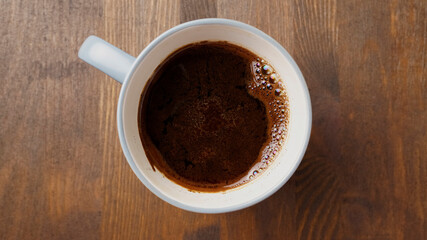 Cup of coffee close-up on a wooden table